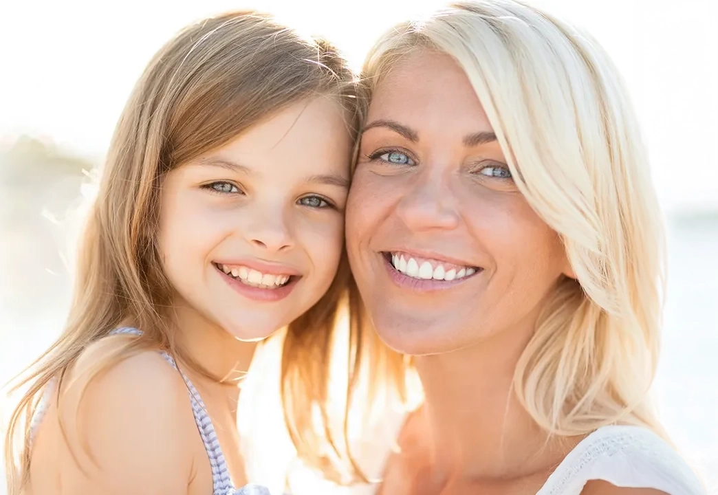 Mother and daughter smiling